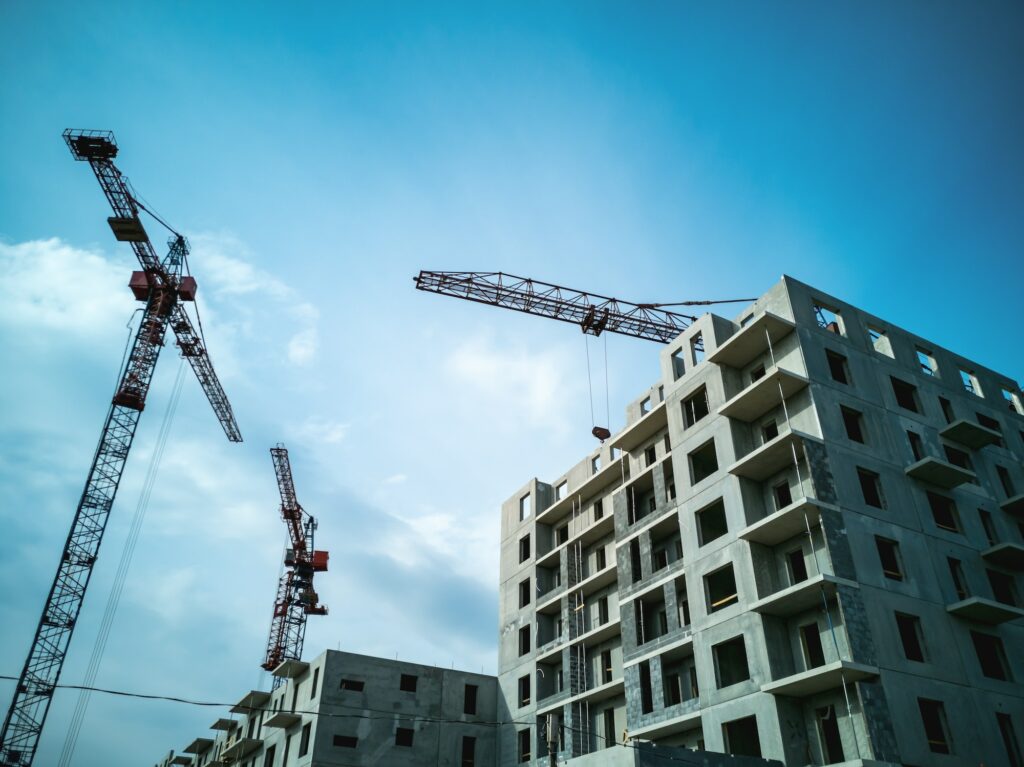 Tower cranes at the construction site. Construction of panel high-rise buildings.